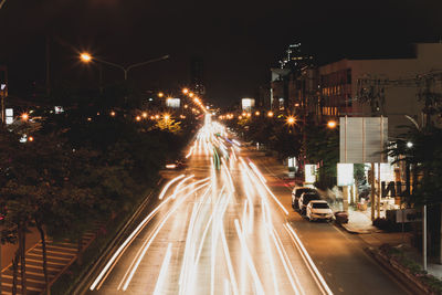 Light trails on road in city at night