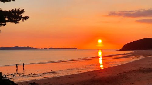 Scenic view of sea against romantic sky at sunset