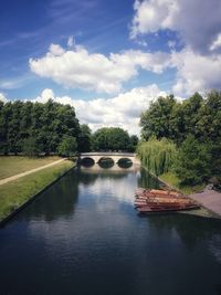 Arch bridge over river against sky