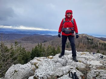 Rear view of man standing on rock