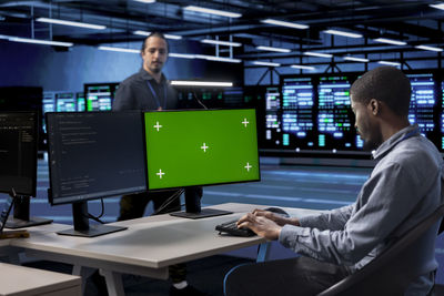 Midsection of man using laptop at office
