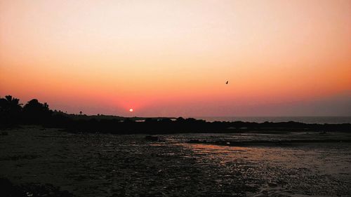 Scenic view of sea against clear sky during sunset