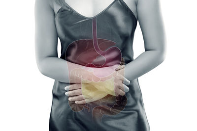 Digital composite image of woman with stomachache against white background