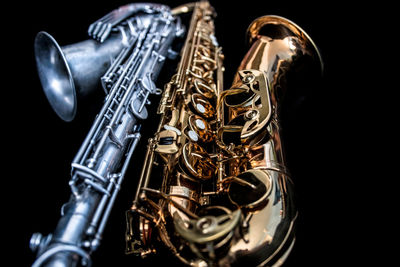 Close-up of saxophone against black background