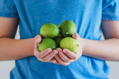 Close-up of man holding fruit