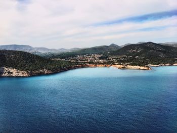 Scenic view of calm sea against cloudy sky