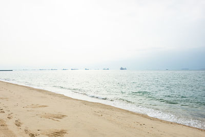 Scenic view of beach against clear sky