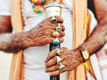 Midsection of man holding hands