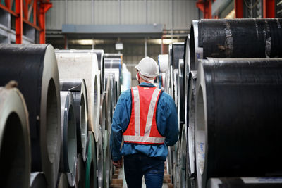 Rear view of woman standing in factory