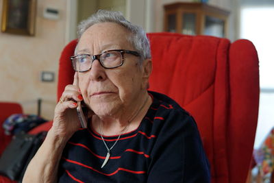 Portrait of man sitting on chair at home