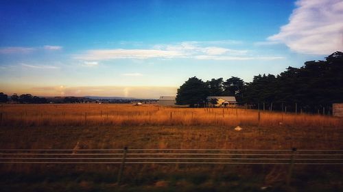 Scenic view of field against sky during sunset