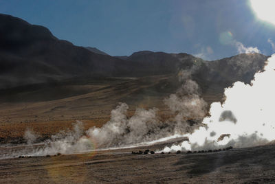 Smoke emitting from volcanic mountain against sky