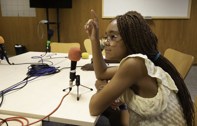 Side view of young woman using mobile phone