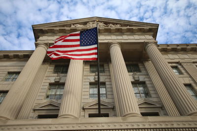 Low angle view of flags against sky