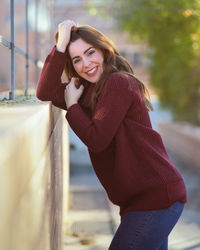 Portrait of smiling young woman standing outdoors