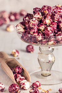 Close-up of sweet popcorns in glass container on table