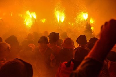 Group of people in party against fire