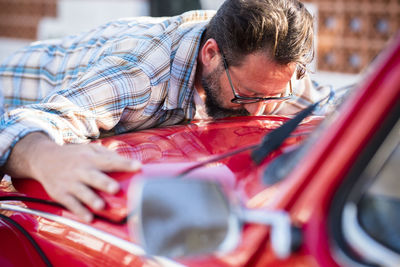 Man kissing car in showroom