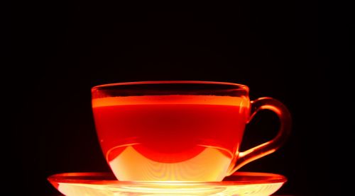 Close-up of tea cup against black background