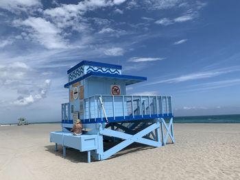 Lifeguard hut on beach against sky