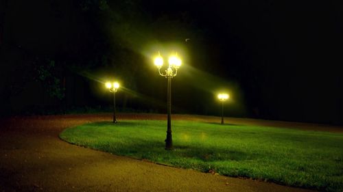 View of illuminated street lights at night