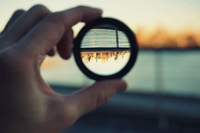 Close-up of man photographing mirror