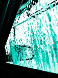 Low angle view of glass window against sky