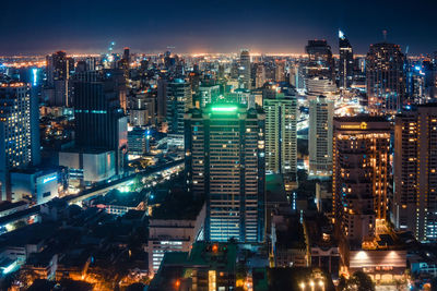 High angle view of illuminated buildings in city at night