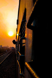 Railroad tracks against sky during sunset