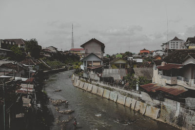 High angle view of townscape by river in city