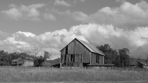 Houses on field against sky