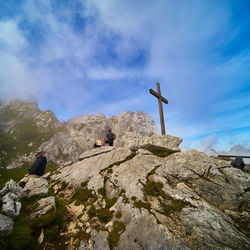 Low angle view of rocks on mountain against sky