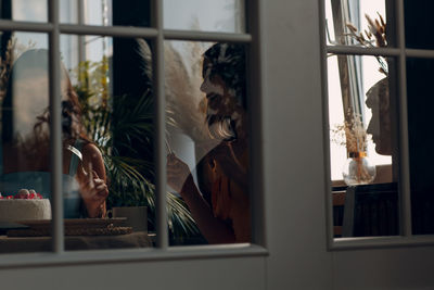 Woman standing by window at store