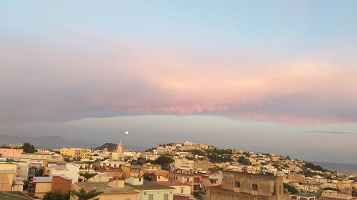 High angle view of townscape by sea against sky