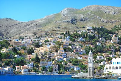 Aerial view of town by sea against clear sky