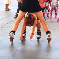 Low section of people walking on tiled floor