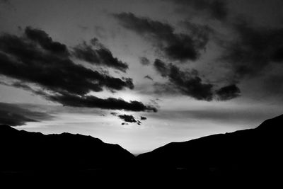 Low angle view of silhouette mountain against dramatic sky