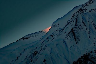 Scenic view of snow covered mountain against sky