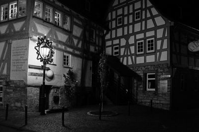 Street amidst buildings in city at night