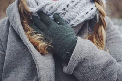 Midsection of woman wearing warm clothing while standing outdoors