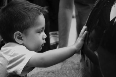 Close-up of baby boy reflecting on metal