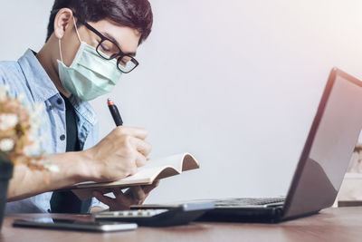 Low angle view of man working on table