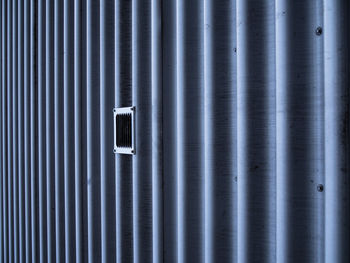 Full frame shot of closed metal grate against wall