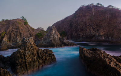 Scenic view of rocks and sea against sky