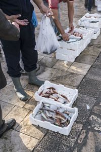 Low section of vendors selling fish at market