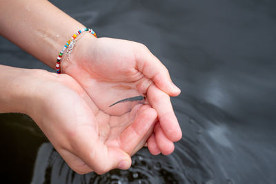 Cropped image of people holding hands