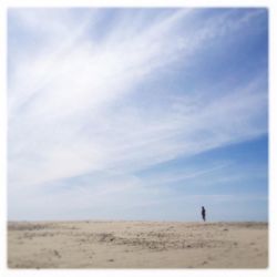 Scenic view of field against cloudy sky