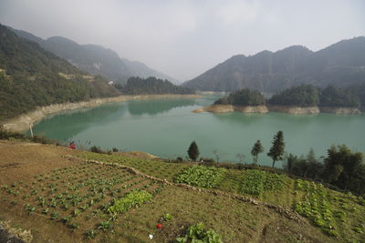 Scenic view of lake and mountains against sky