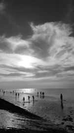 People on beach against sky