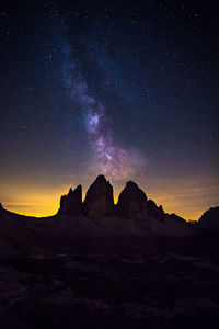 Scenic view of mountains against sky at night